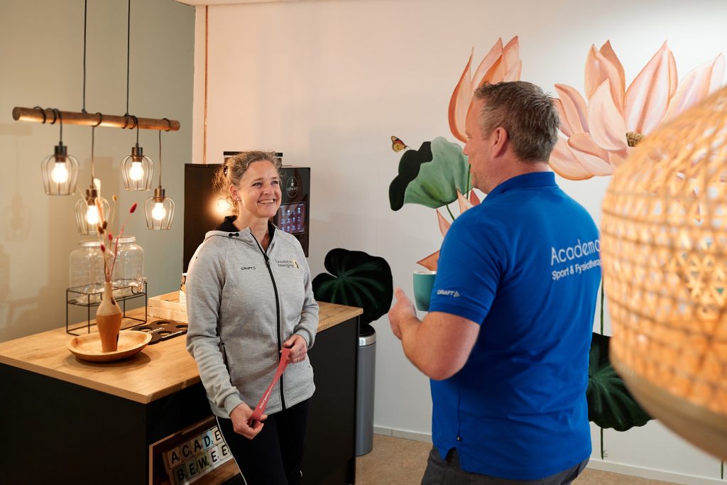 man en vrouw in gesprek bij koffiemachine